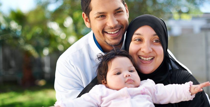 Des parents musulmans tiennent dans leurs bras leur bébé